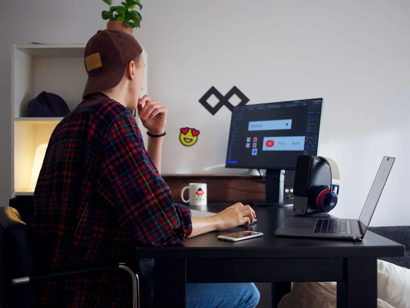 A designer working on a website layout at a desk