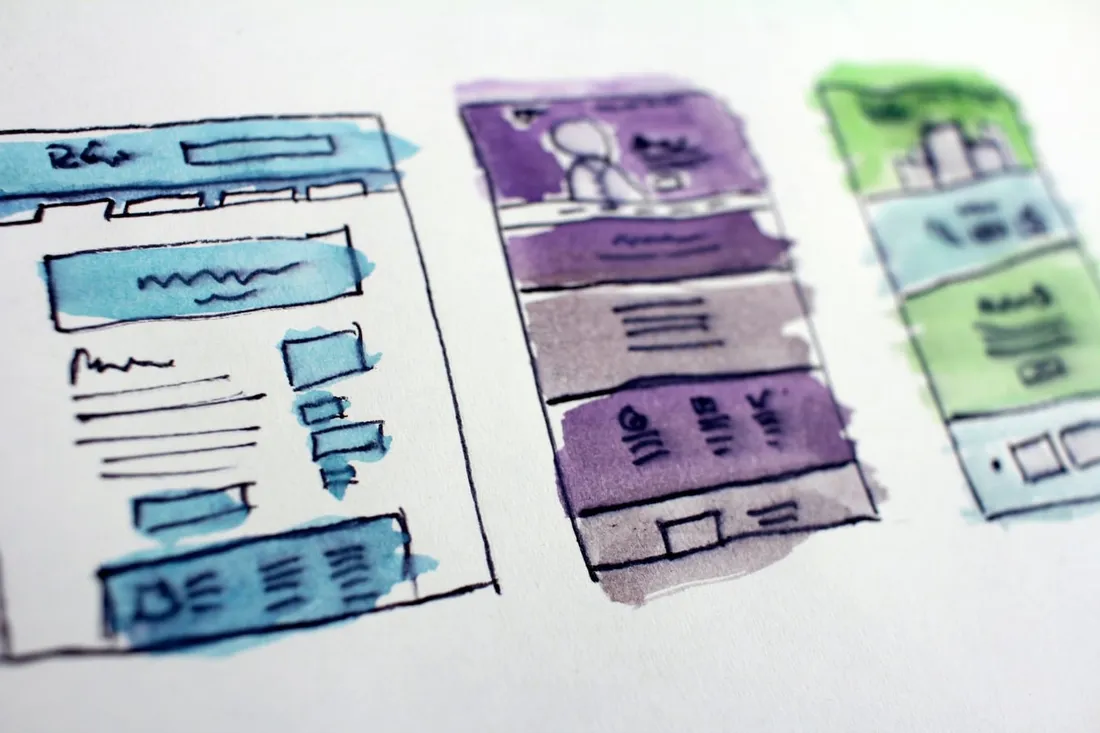 Hand-drawn website wireframes coloured in watercolour